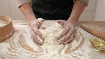 A person is kneading dough on a table video