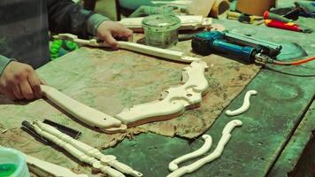 Craftsman assembles parts of furniture frame. Carpenter is busy with his favorite work. High-quality footage 4k video