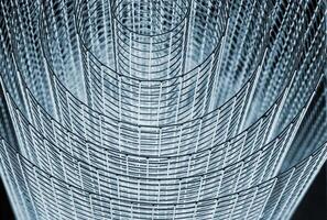 Abstract spiral metal coiled wire mesh with grid pattern, geometric symmetry, modern minimal design for industrial construction, diy, architectural concepts. Isolated on white background. Copy space photo