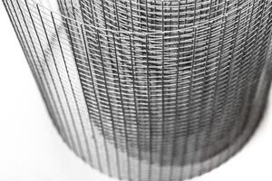 Abstract spiral metal coiled wire mesh with grid pattern, geometric symmetry, modern minimal design for industrial construction, diy, architectural concepts. Isolated on white background. Copy space photo