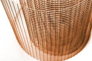 Abstract spiral metal coiled wire mesh with orange brown grid pattern, geometric symmetry, minimalist design for industrial construction, diy concepts. Isolated on white background. Copy space photo