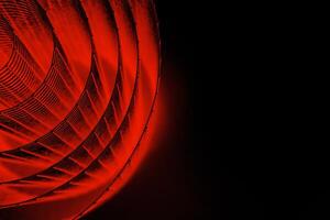 Abstract spiral with glowing red wire texture against a black background, symbolizing color contrast, energy, motion, industrial and futuristic design concepts. Copy space photo