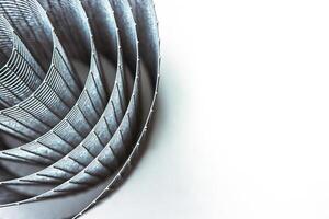 Abstract spiral metal coiled wire mesh with grid pattern, geometric symmetry, modern minimal design for industrial construction, diy, architectural concepts. Isolated on white background. Copy space photo