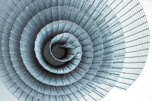 Abstract spiral metal coiled wire mesh with grid pattern, geometric symmetry, modern minimal design for industrial construction, diy, architectural concepts. Isolated on white background. Copy space photo