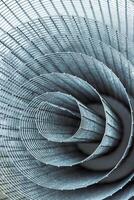 Abstract spiral metal coiled wire mesh with grid pattern, geometric symmetry, modern minimal design for industrial construction, diy, architectural concepts. Isolated on white background. Copy space photo