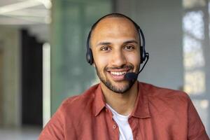 Happy customer service agent with headset providing assistance remotely. Confident professional delivering excellent support in modern office setting with friendly demeanor. photo