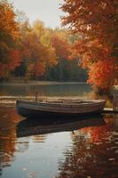 A tranquil autumn scene with a wooden boat on a serene lake surrounded by colorful foliage. photo