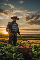 A farmer stands in a field at sunset, next to a basket filled with fresh produce. photo