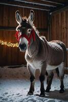 A donkey with a red ribbon stands in a snowy barn, illuminated by warm lights. photo