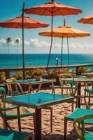 Beachside caf with colorful umbrellas and tables overlooking the ocean. photo
