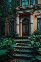 An inviting entrance to an old building surrounded by lush greenery and steps. photo