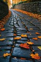 A winding cobblestone path adorned with autumn leaves in a serene environment. photo