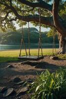 A serene swing hangs from a tree by a tranquil lake, inviting relaxation and play. photo