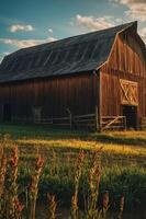 A rustic barn stands amid golden fields under a vibrant sky, evoking a serene countryside. photo