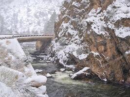 mountain river in heavy springtime snowstorm photo