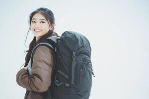 A woman with a backpack smiling photo