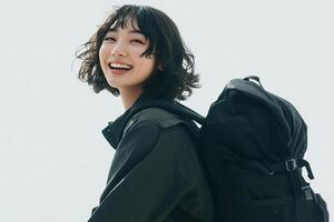 A woman with a backpack smiling photo