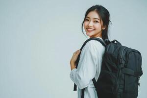 Asian woman with backpack smiling and looking at camera photo