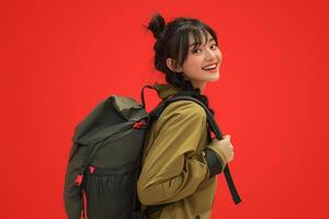 A woman with a backpack on a red background photo
