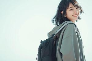 A young woman with a backpack smiling photo