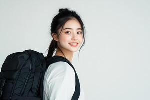 Portrait of asian girl with backpack on white background photo
