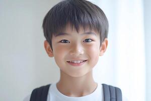 A young boy with a backpack smiling photo