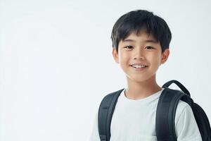 A young boy with a backpack smiling photo