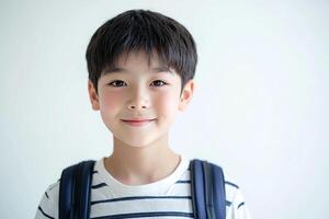 A young boy with a backpack and a smile photo