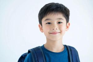 A young boy with a backpack smiling photo