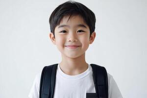 A young boy with a backpack smiling photo