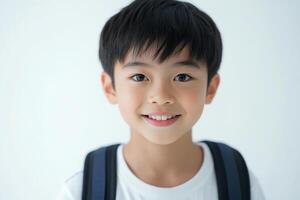A young boy with a backpack smiling photo