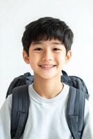A boy with a backpack smiling photo