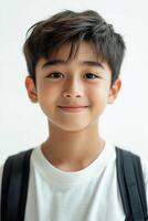 A young boy with a backpack smiling photo