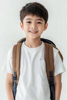 A boy with a backpack standing in front of a white background photo
