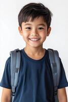 A young boy with a backpack smiling photo