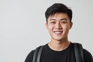 Asian young man with backpack smiling photo