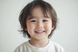 A young child is smiling and looking at the camera photo