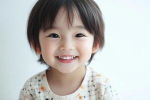 A little girl is smiling and looking at the camera photo