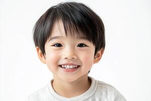 A young boy is smiling and looking at the camera photo