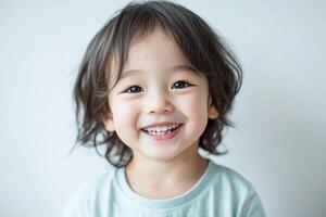 A young child is smiling and looking at the camera photo