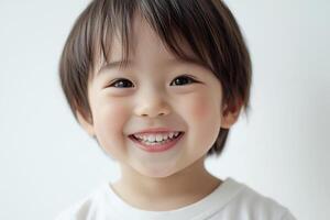 A young child is smiling and looking at the camera photo