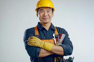 A man in a hard hat and overalls holding a toolbox photo