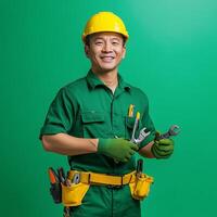 A man in a green uniform holding tools photo