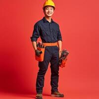 A young man in a hard hat and overalls holding a tool belt photo