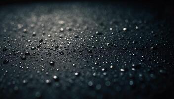 Water drops on a black surface photo
