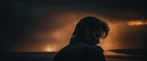 A man standing in front of a stormy sky photo