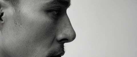 A man with a shaved head and a beard photo