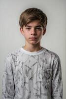 A boy in a white shirt with a black and white pattern photo