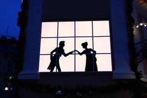 Silhouetted Romance Captured Behind a Window at Dusk, A Perfect Blend of Love and Atmosphere photo
