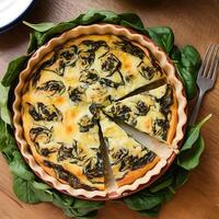 A quiche with spinach on a table photo